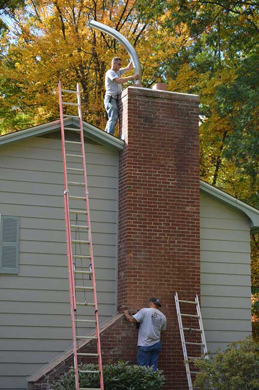 men installing chimney liner