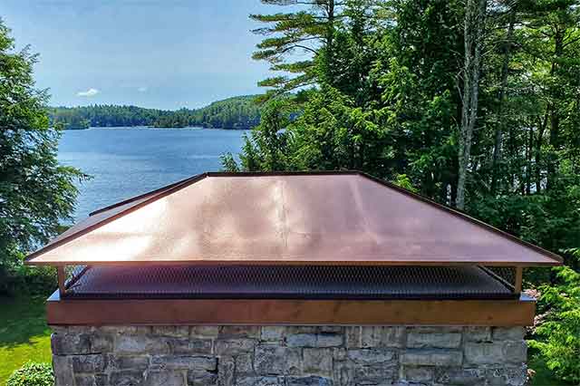 Brand new copper chimney cap with lake in the background