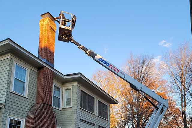 Tech on a lift putting on a new cap and cover 