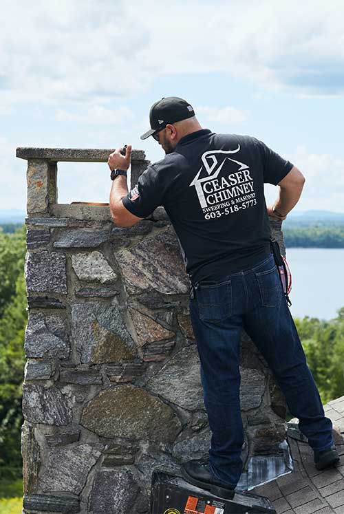 Ceaser's Chimney original photo of Chimney Inspection Ceaser's Chimney original photo of inspection with video equipment and black logo shirt