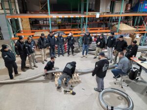 Team Photo - demonstration of chimney liner in warehouse