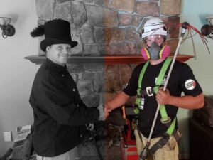 Team Photo of two team members one dressed with safety equipment and broom the other dressed like a sweep in front of a fireplace