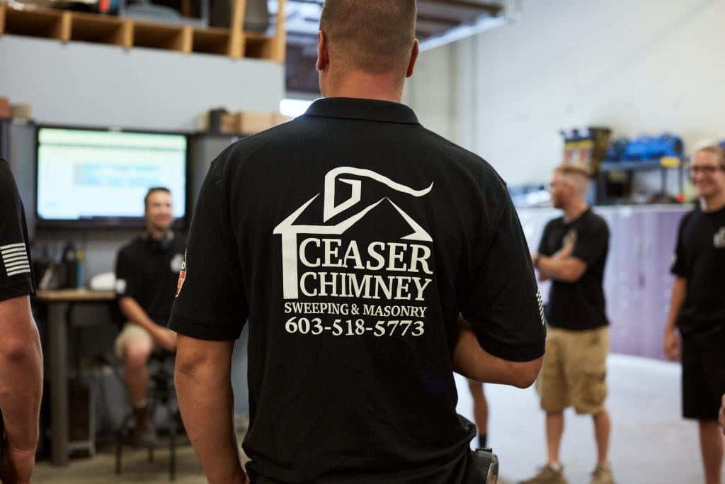 Original photo of a Ceaser Chimney employee, showcasing the back of his shirt with company info.